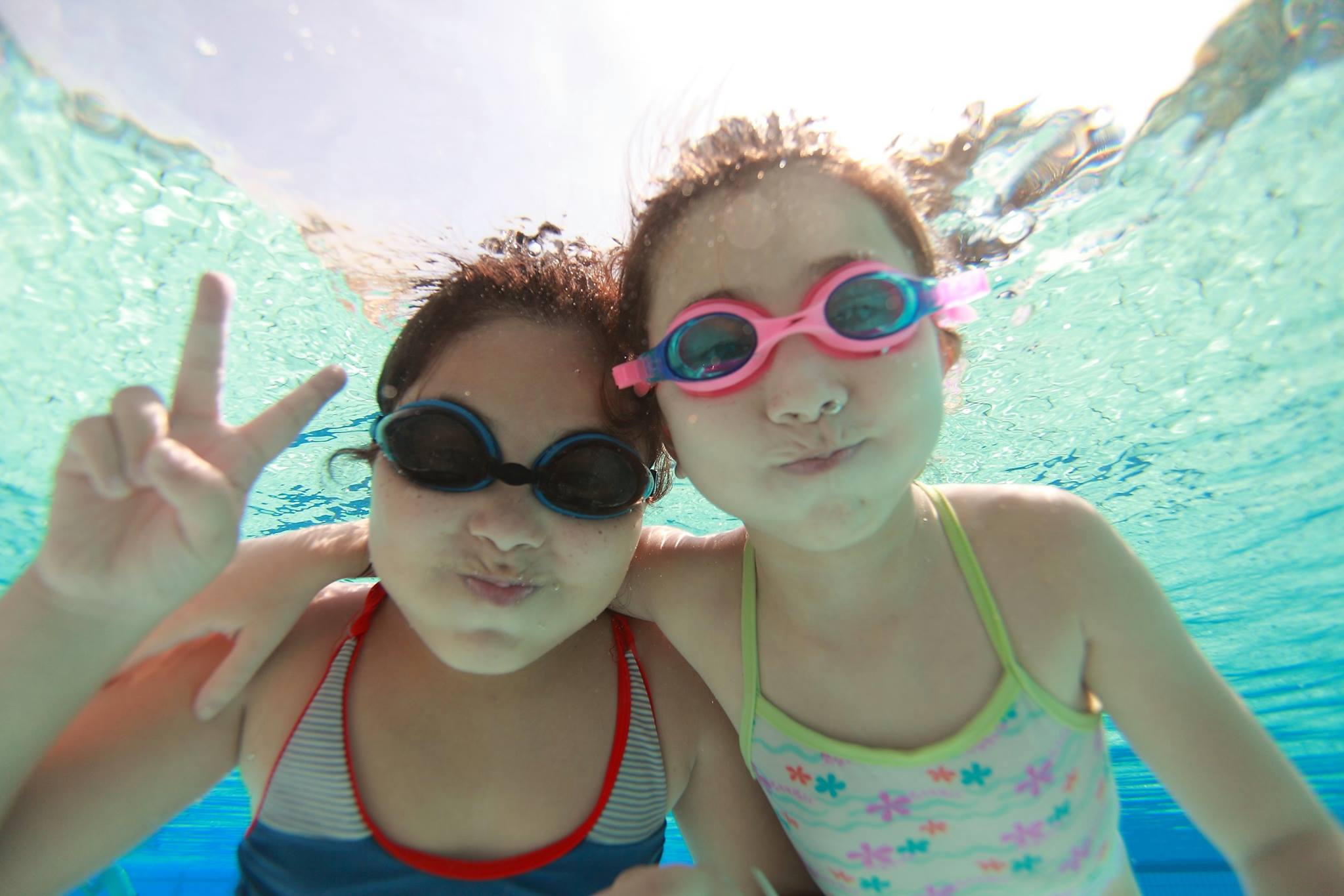 Animated family with adults and kids that are wearing swimming suits